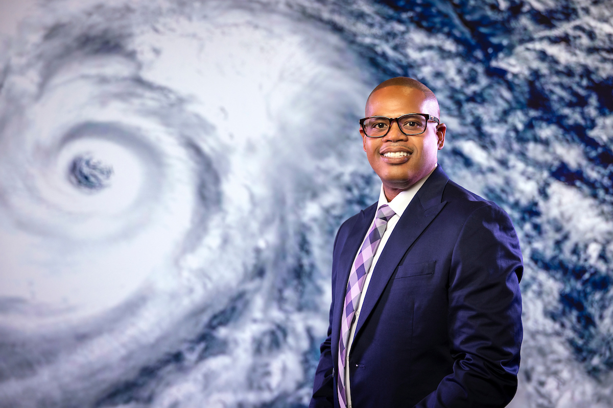 Portrait of Michael Antoine with hurricane image in the background