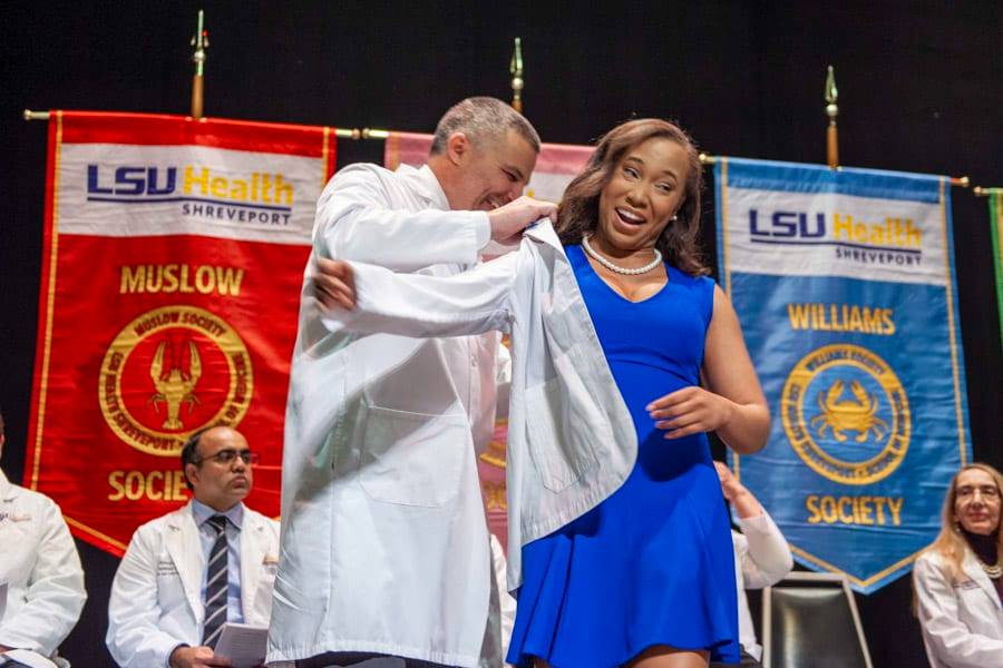 A LSU Health Shreveport medical student receives her white coat during the White Coat Ceremony