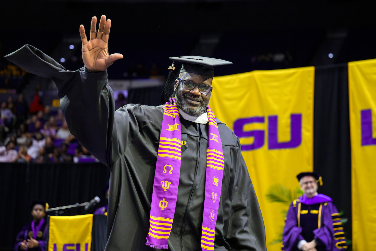 Shaquille O'Neal waves after receiving his degree