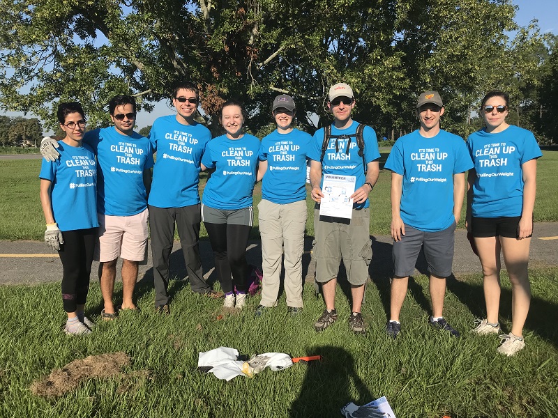 a group of students in matching t-shirts pose outdoors