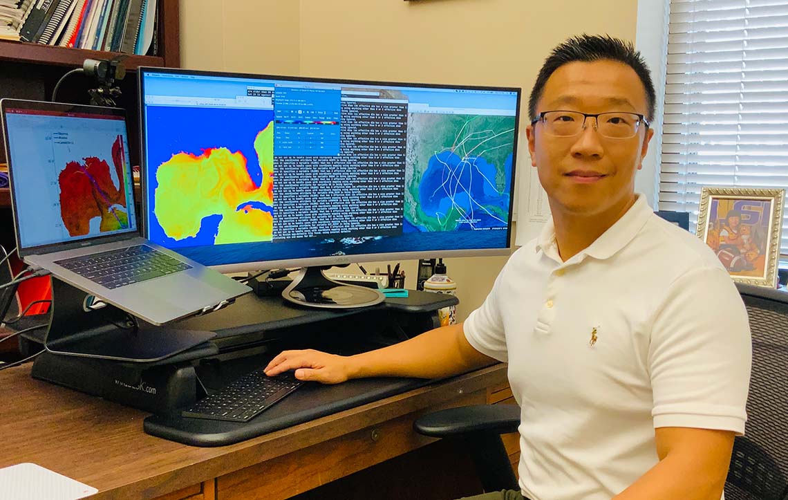 Z. George Xue sits in front of a computer showing a coupled model