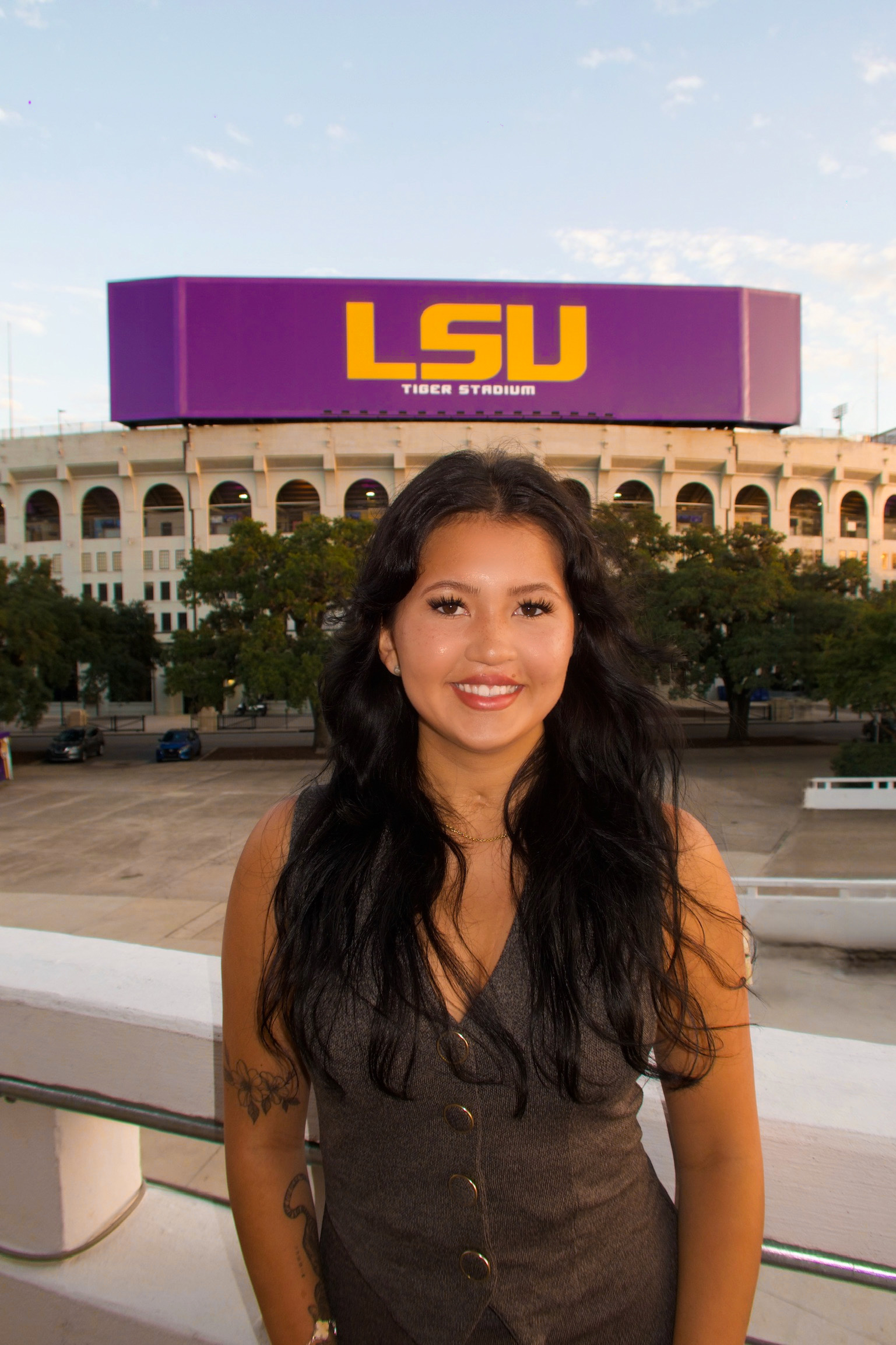 LSU Kinesiology student Kaitlyn Bartolutti in front of the LSU sign at Tiger Stadium