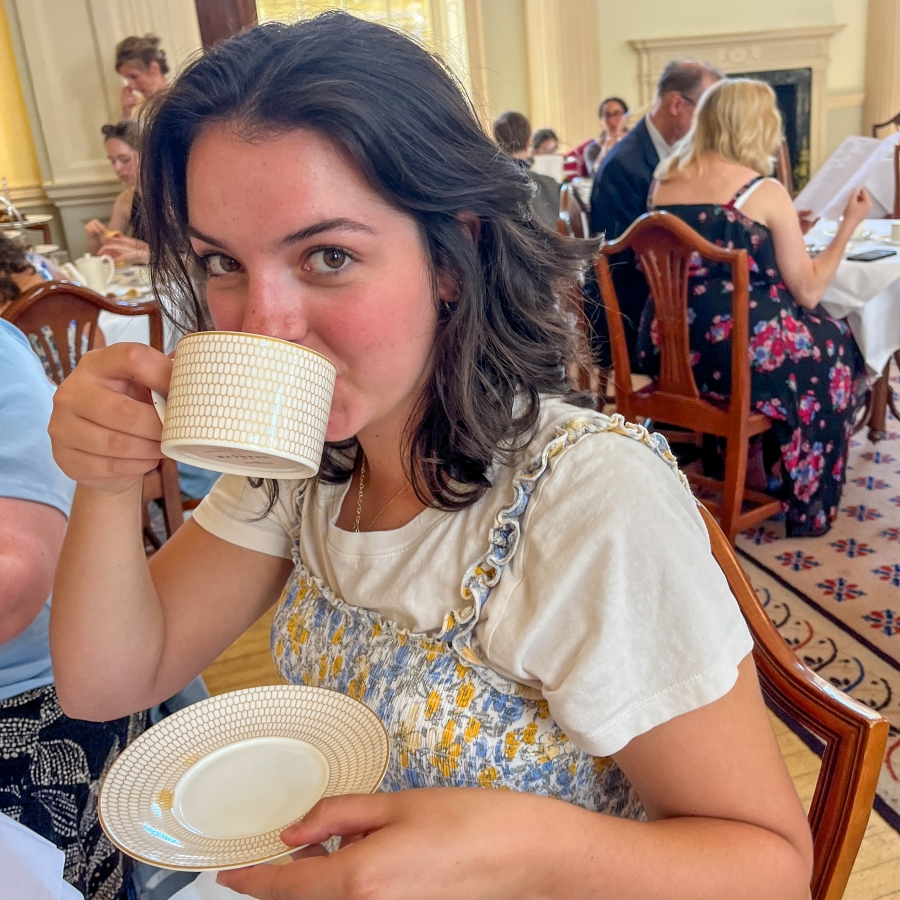 student sips tea in an English tea room