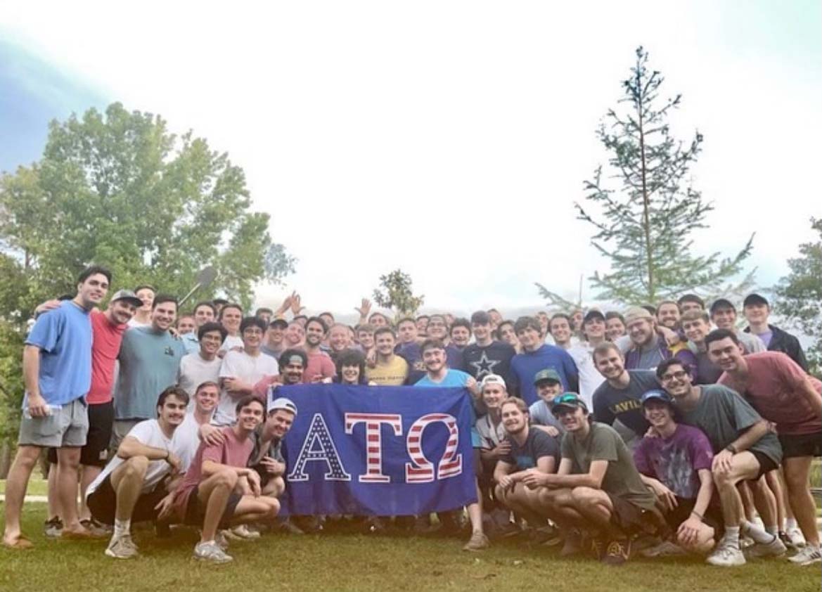 IFC members behind their chapter flag