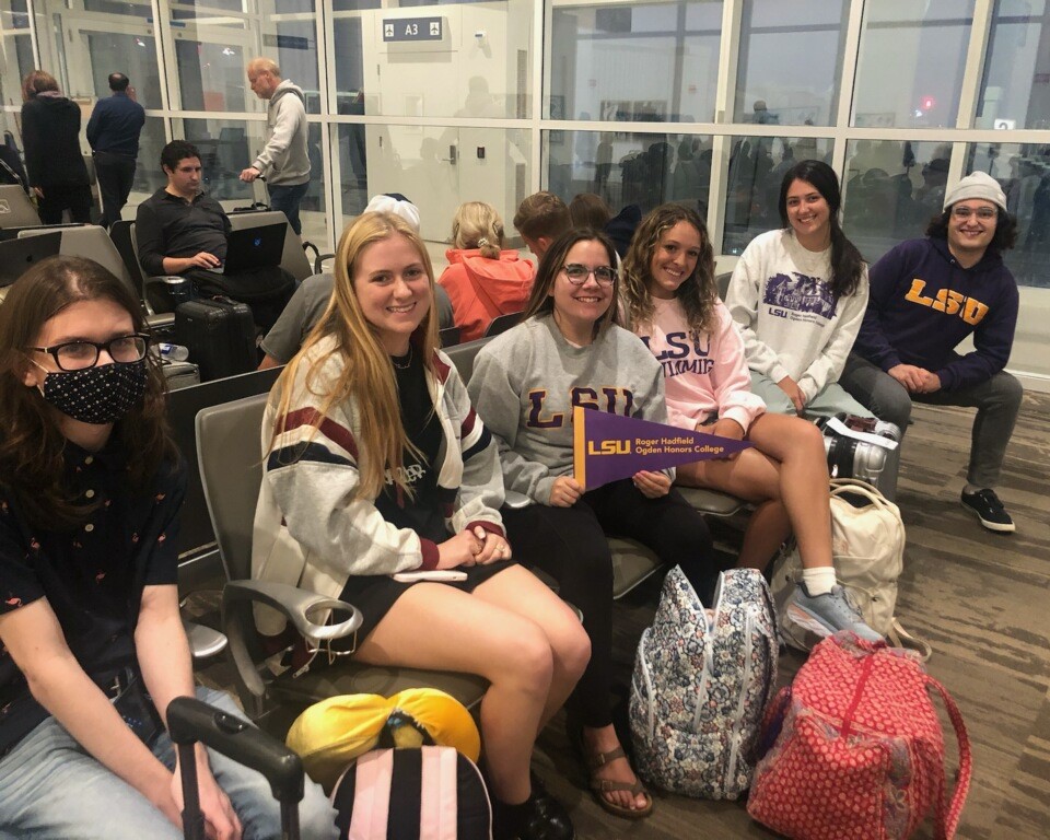 OHC students sitting at the airport, waitinng to board the plane to England