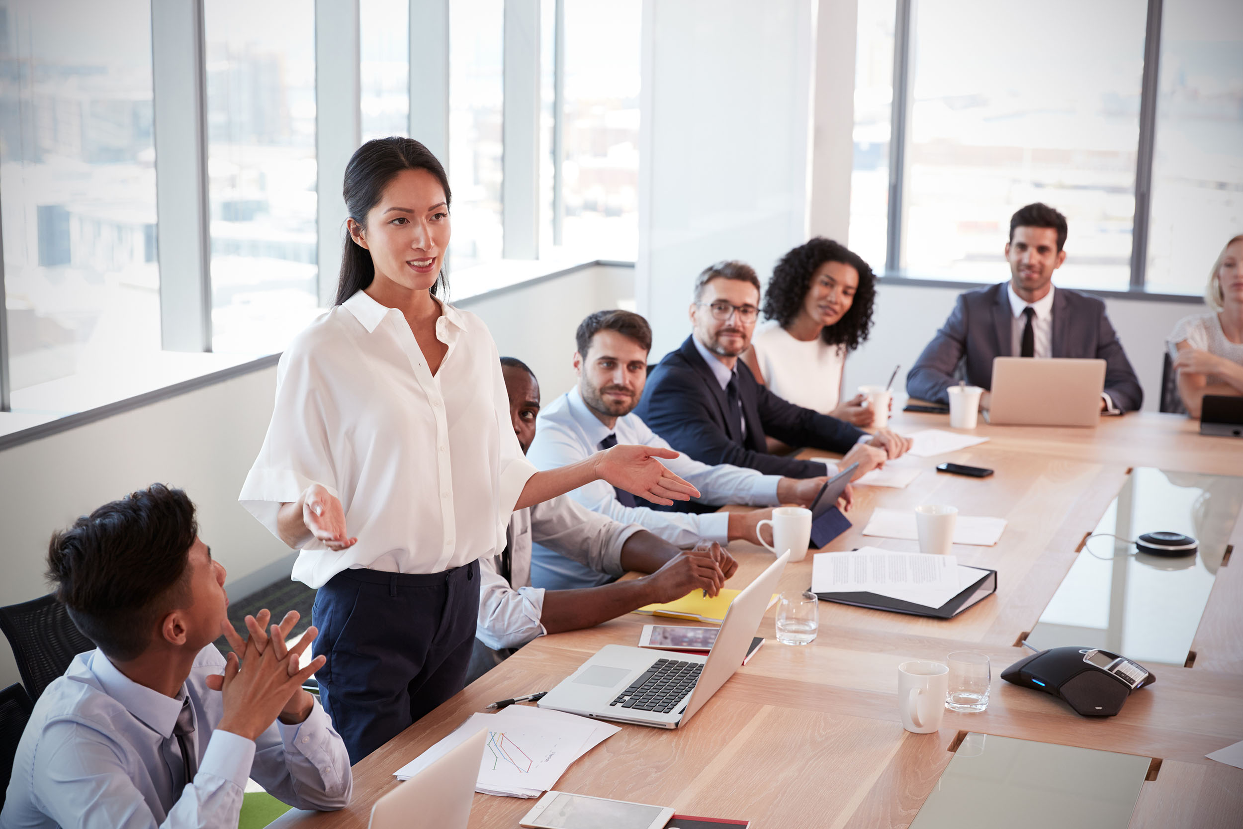 image of young female professional leading a meeting in a conference room