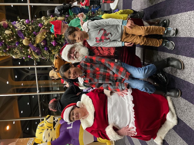 Santa Claus and Mrs. Claus with children